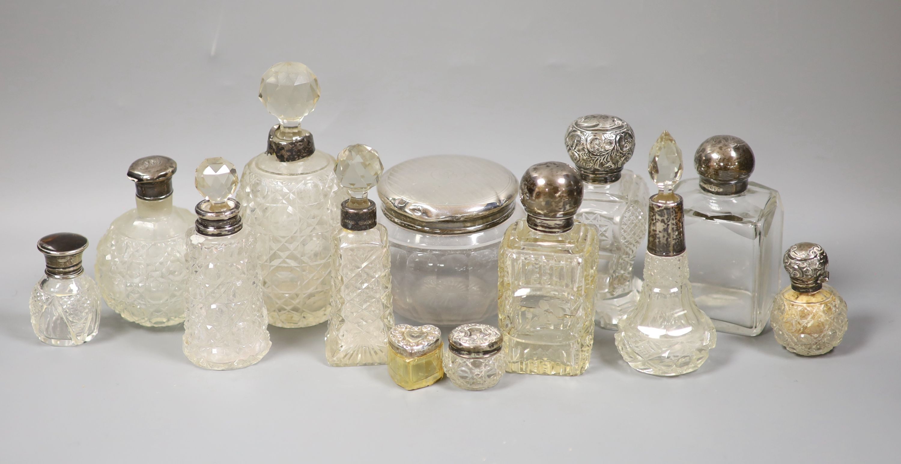 A collection of assorted silver mounted glass scent bottles, toilet jars etc. (a.f.)